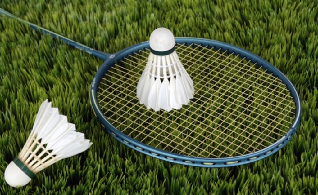 Badminton rackets and shuttlecocks on grass