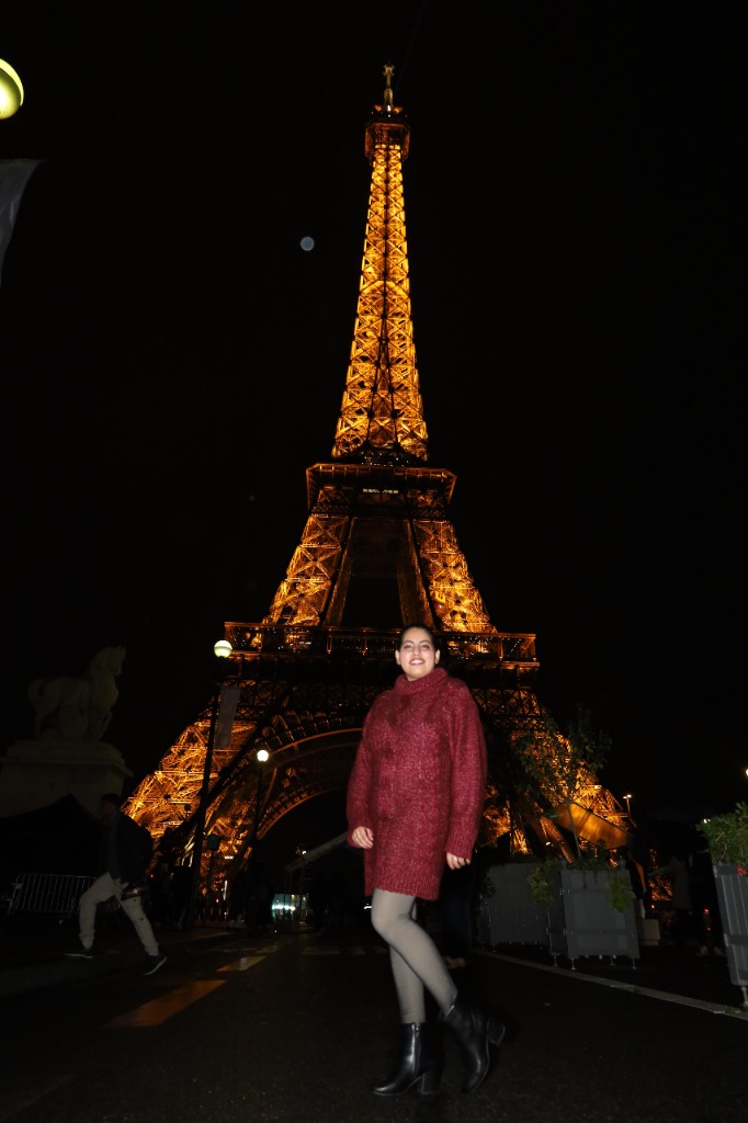 Sampada in front of the Eiffel Tower at night