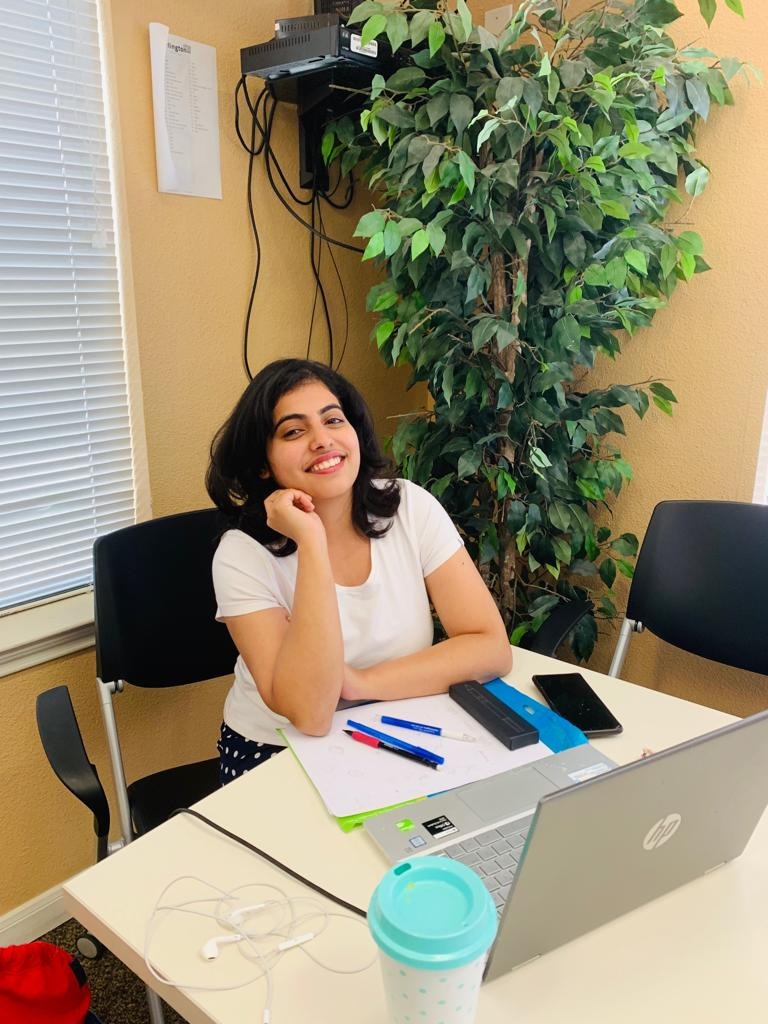 Sampada smiling at desk