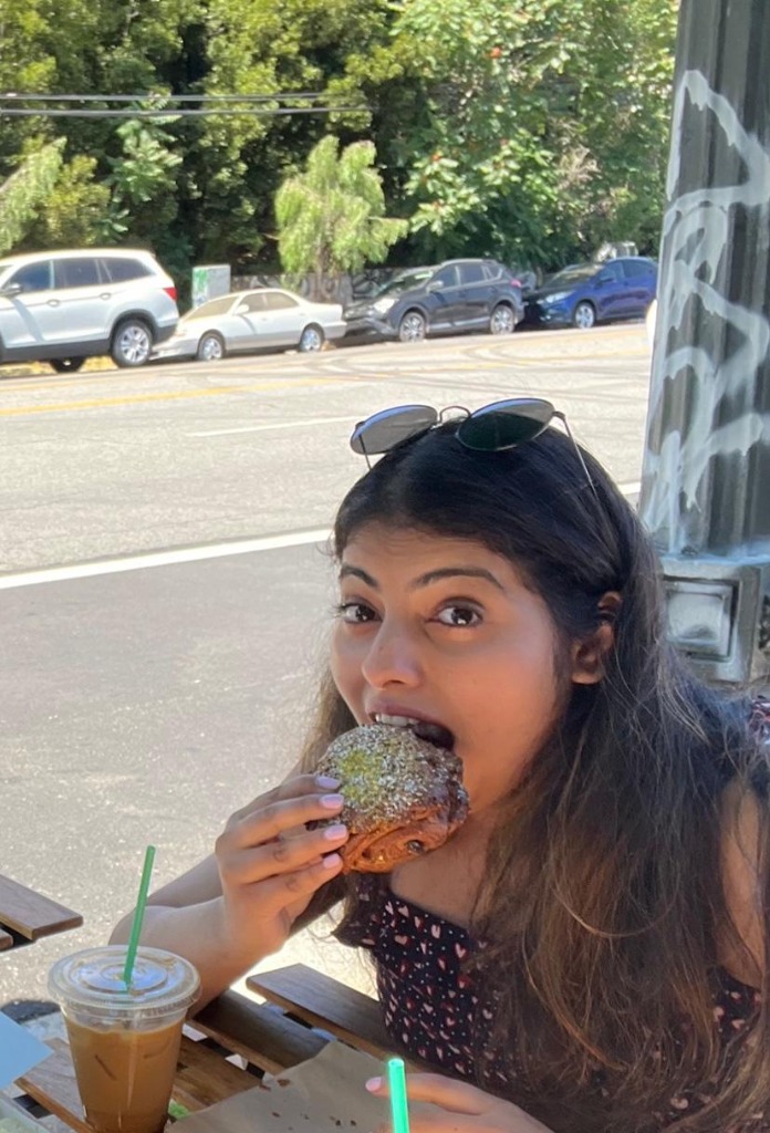Sampada taking a bite out of a delicious pastry